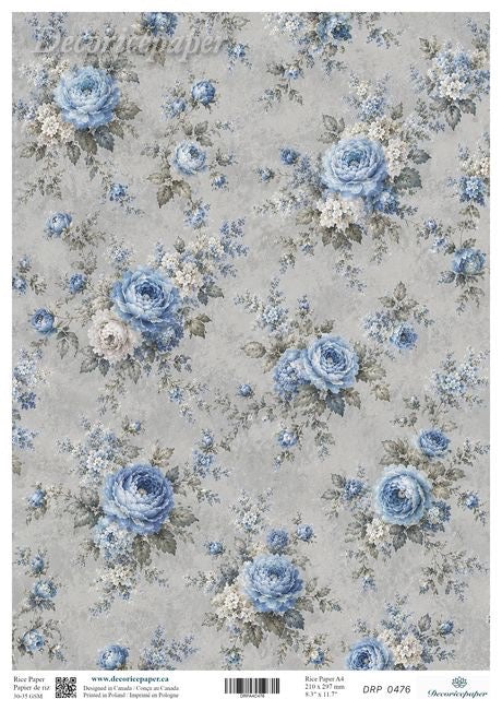 A sheet of decorative paper featuring a vintage floral pattern with blue roses and small white blossoms on a textured light gray background.