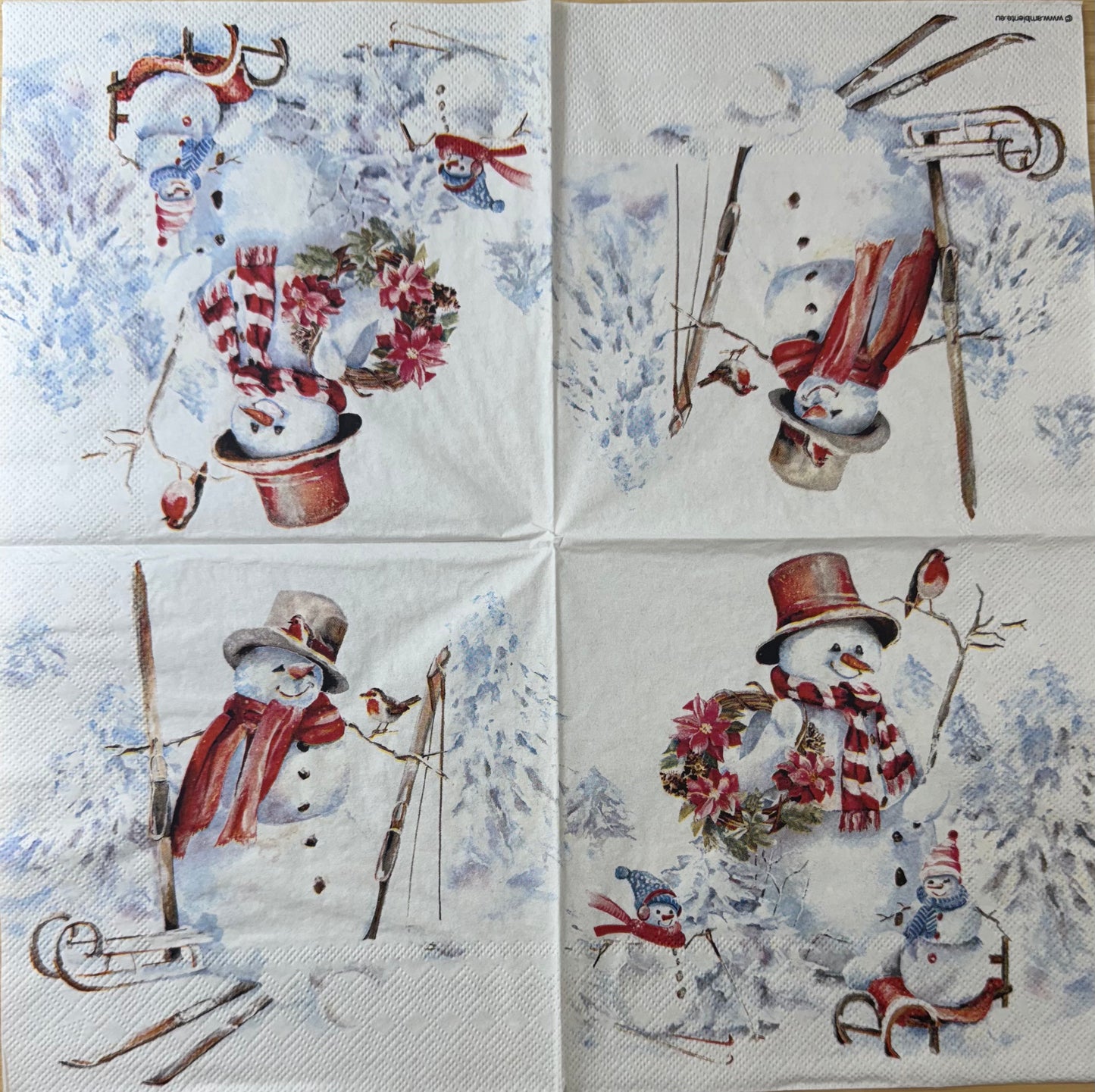Unfolded decorative paper napkin featuring four snowmen with winter accessories on a snowy background.