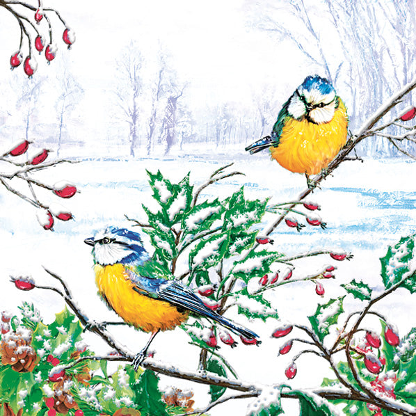 A paper napkin with a printed winter scene featuring two yellow, blue, and green birds perched on branches with red berries, with a snowy landscape in the background.