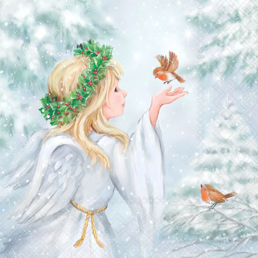 A soft, painterly winter scene showing a blonde angel in a white robe with wings and a green wreath, reaching toward a small orange bird while snow falls. Another small bird sits on a branch nearby against a snowy, misty background.