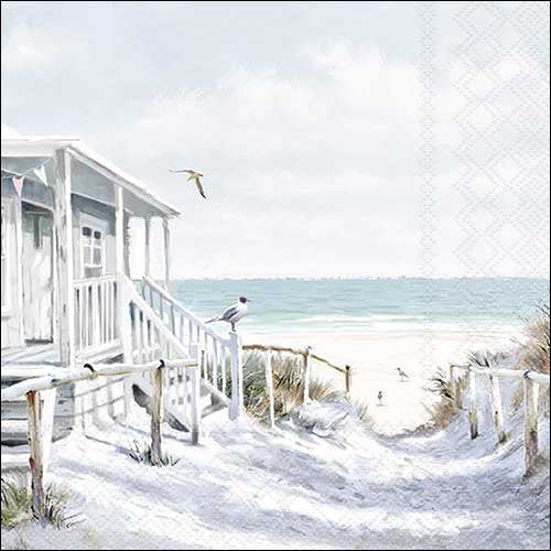 White beach house with a staircase leading to the ocean, with birds in the air.