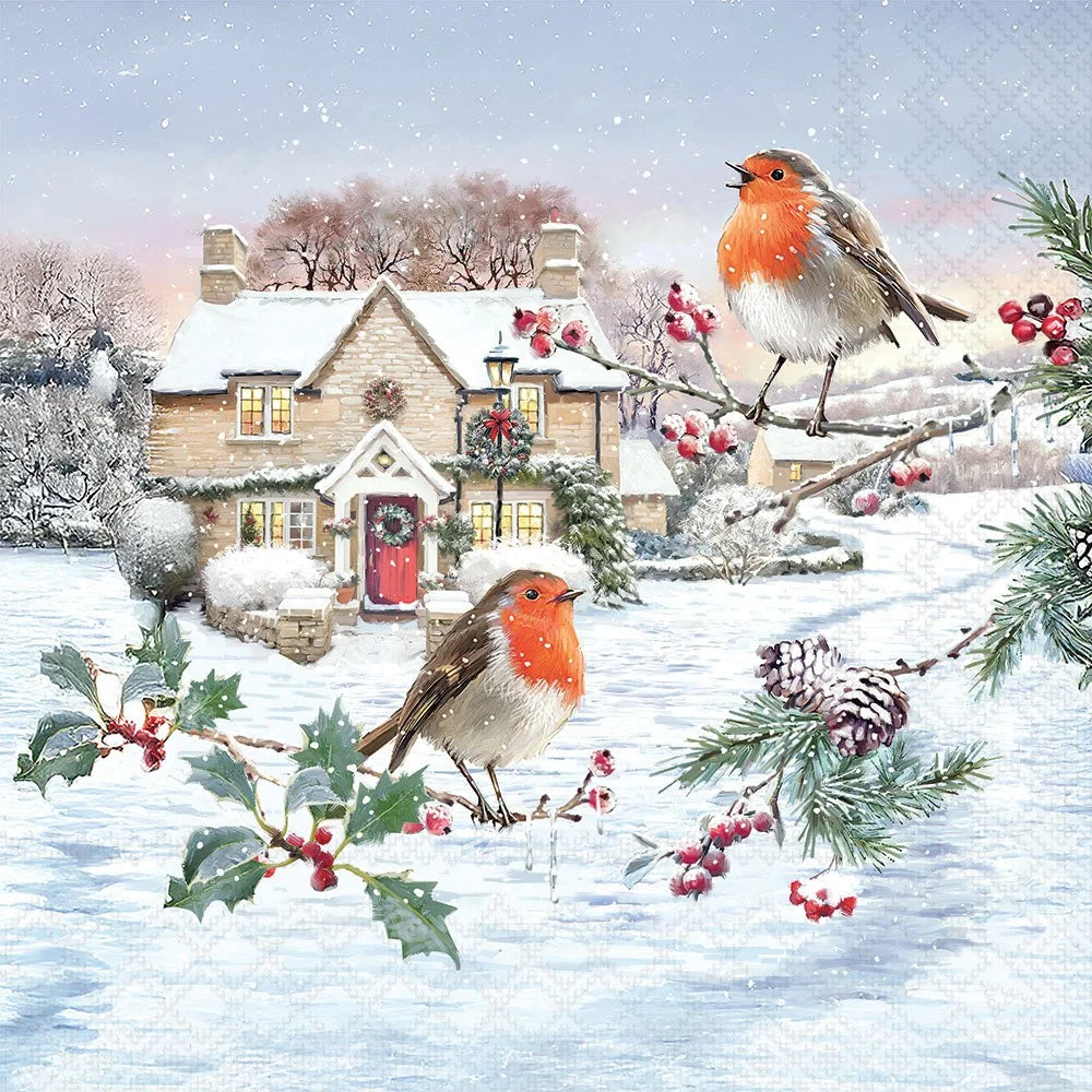 A festive winter scene print featuring two robin birds perched on snowy branches with holly and pinecones in front of a snow-covered cottage.