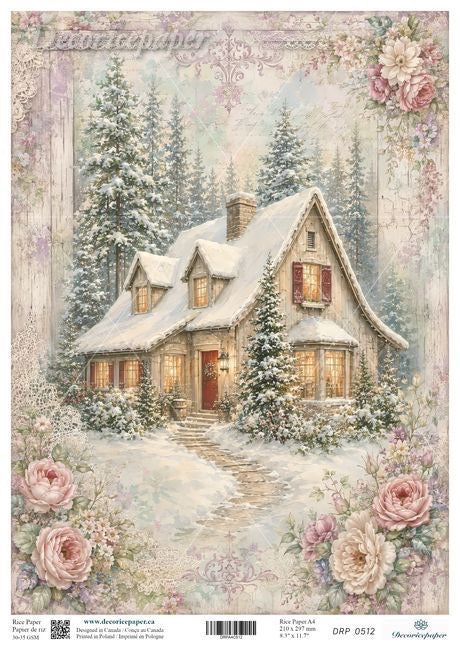A vintage-style winter cottage scene printed on a decorative paper sheet, showing a snow-covered house with warm glowing windows, evergreen trees, and large pink roses around the border. 