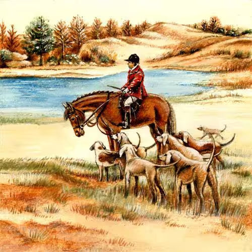 Horseback rider with dogs near a body of water in a scenic landscape