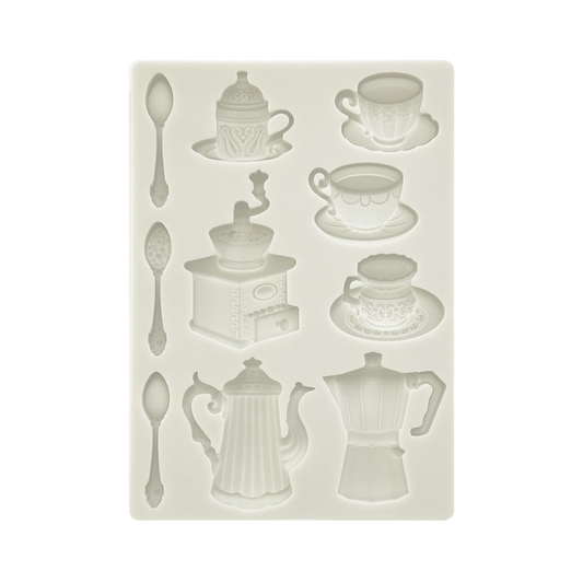 An off-white silicone mold featuring embossed designs of cups, spoons, a coffee grinder, a coffee pot, and a moka pot.