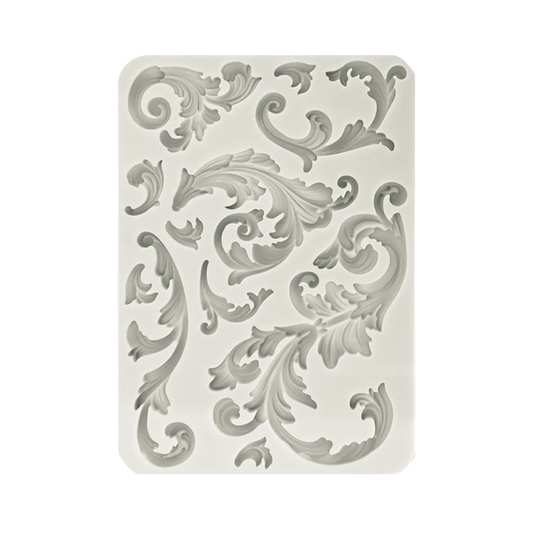 A rectangular silicone mold with a raised baroque scroll and acanthus leaf pattern.