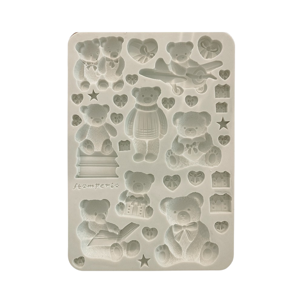 A rectangular silicone mold with embossed teddy bear and heart-shaped cavities,