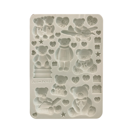 A rectangular silicone mold with embossed teddy bear and heart-shaped cavities,