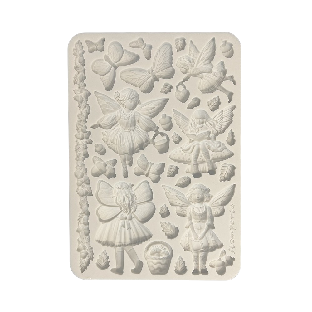 A rectangular silicone mold with embossed fairy and nature designs, including butterflies, leaves, acorns, and small figures.