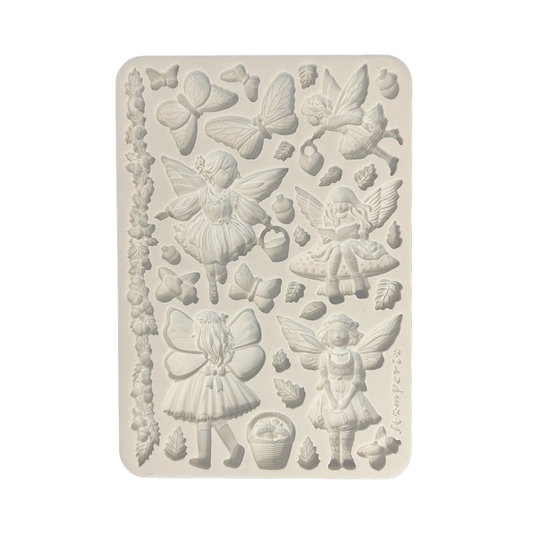 A rectangular silicone mold with embossed fairy and nature designs, including butterflies, leaves, acorns, and small figures.