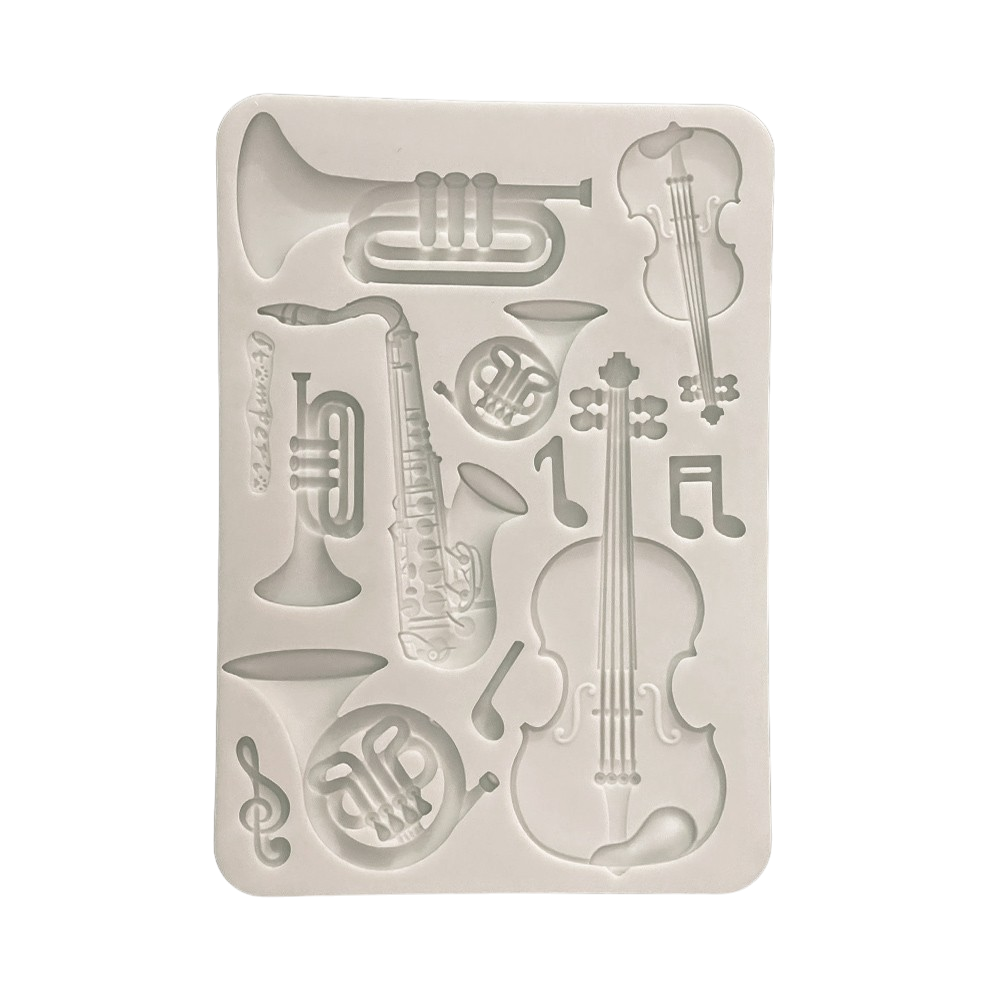 A rectangular white silicone mold featuring embossed musical instruments and notes, including a cello, trumpet, saxophone, French horn, and treble clef.