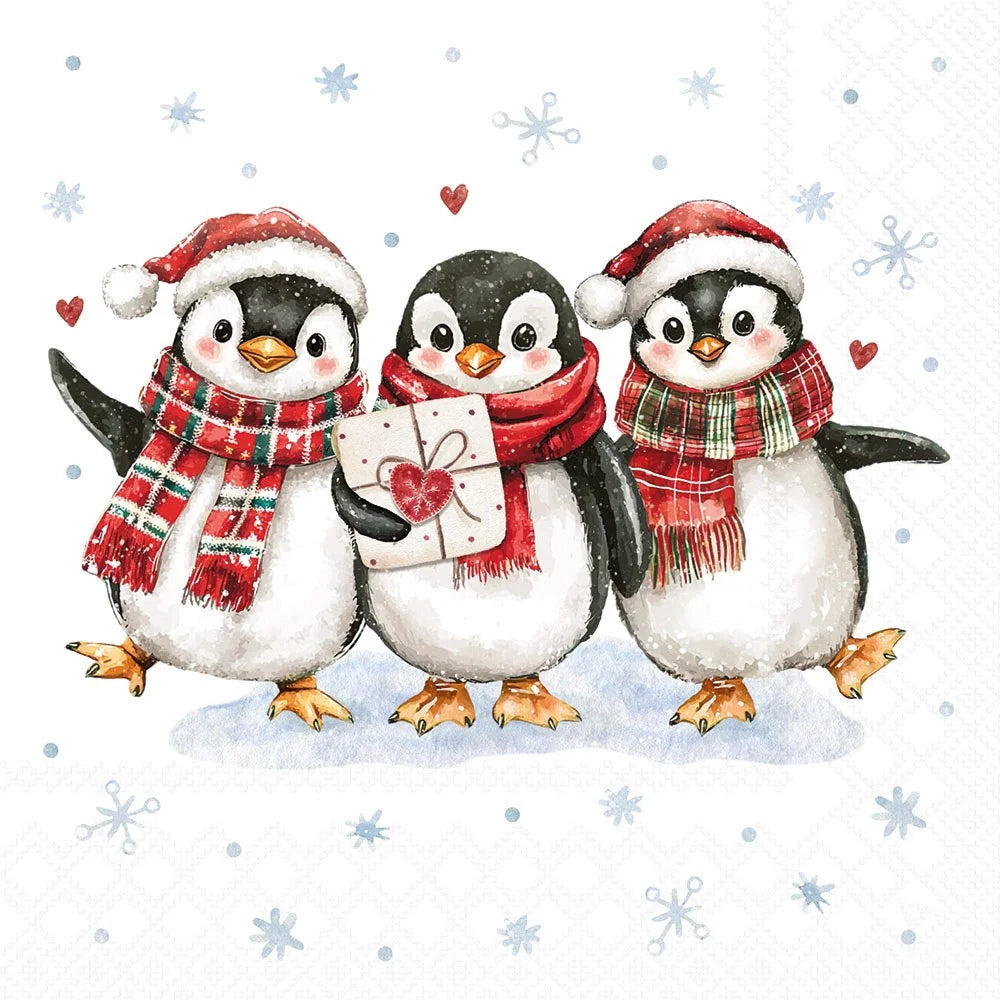 A festive illustration of three penguins wearing Santa hats and red plaid scarves, with the center penguin holding a wrapped gift box with a heart on a white background decorated with snowflakes and small red hearts.