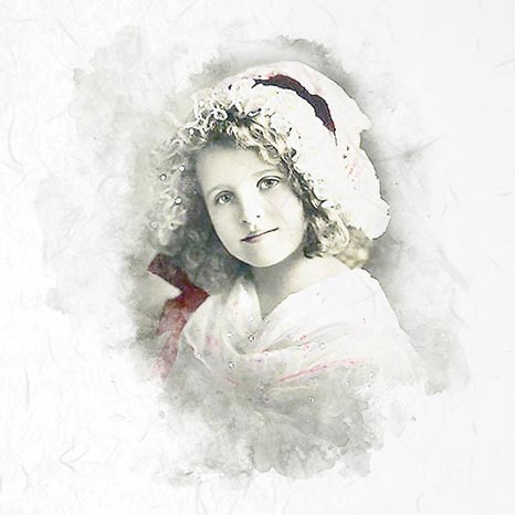 Vintage photograph of a young girl wearing a decorative hat and shawl.