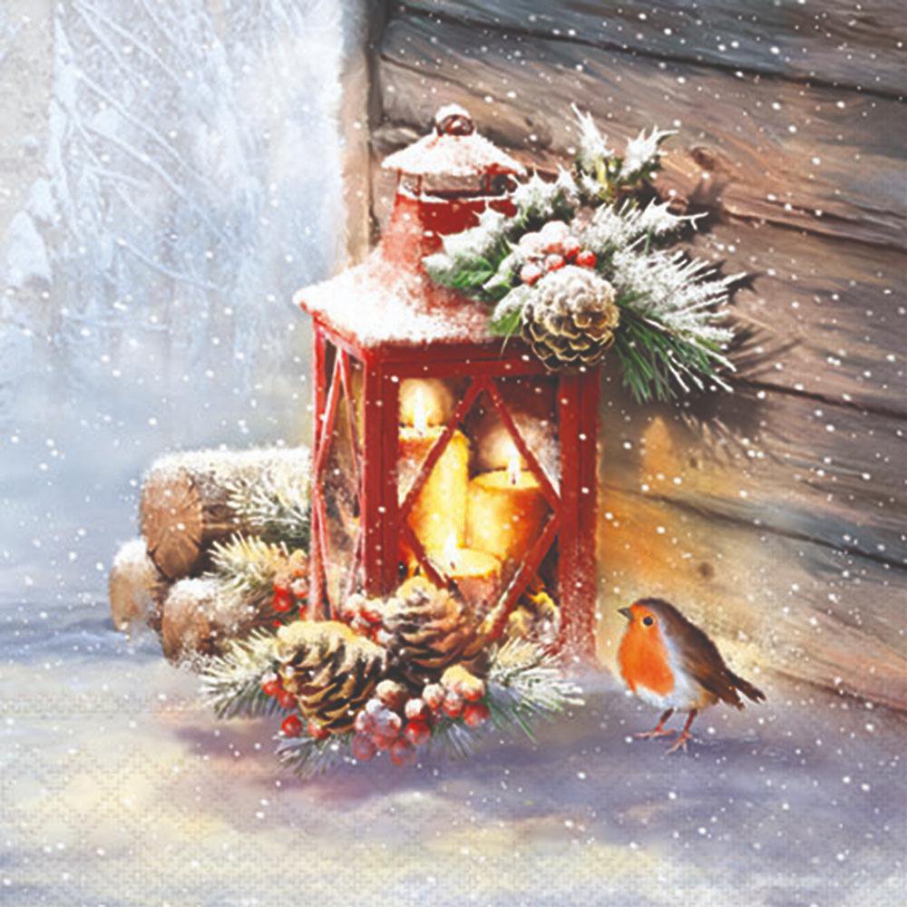 Decorative Christmas lantern with candles, pinecones, and a robin in a snowy setting.