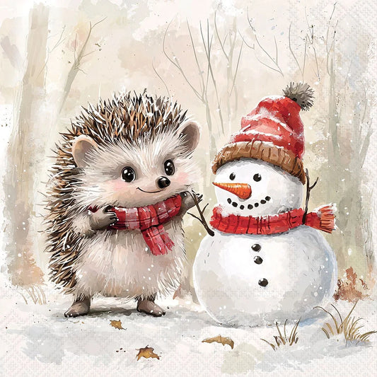 A watercolor-style winter illustration showing a small hedgehog in a red plaid scarf standing beside a snowman wearing a red and brown hat and matching scarf, with a soft snowy forest background.