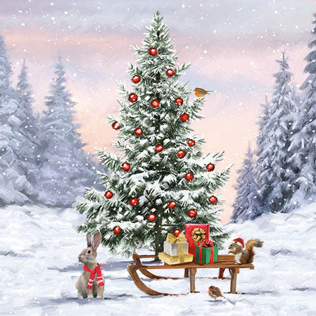 Decorated Christmas tree with presents in a snowy landscape